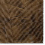 Detail of a handmade wallpaper swatch with a dimensional combed pattern in dark brown.
