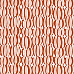 Detail of fabric in an abstract curvilinear print in red and pink on a white field.