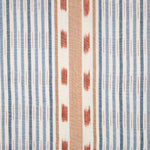 Detail of fabric in a global stripe print in blue, orange and rust on a white field.