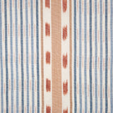 Detail of fabric in a global stripe print in blue, orange and rust on a white field.