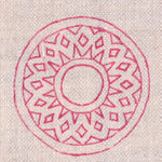 Detail of fabric in a repeating circular geometric print in fuchsia on a cream field.