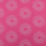 Detail of fabric in a repeating circular geometric print in light gray on a fuchsia field.