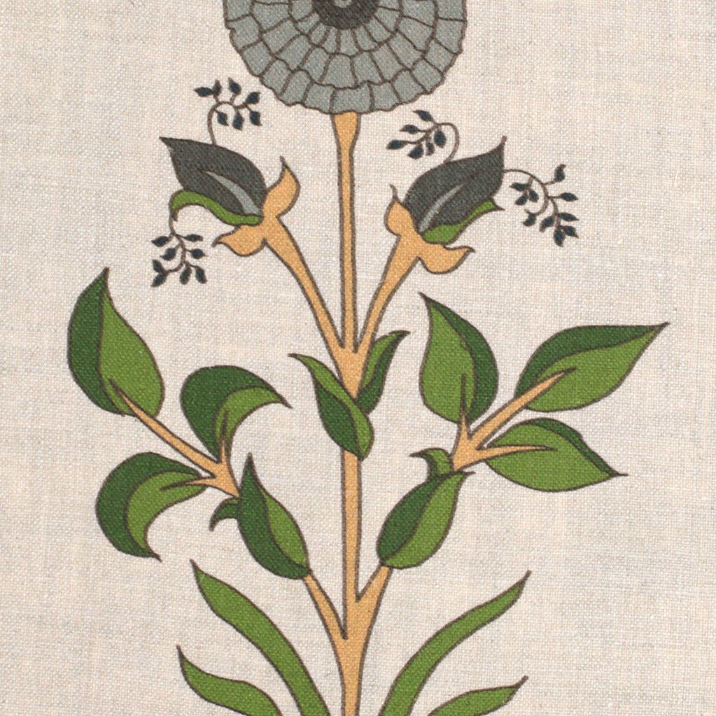 Detail of fabric in a large-scale marigold print in gray, orange and green on a cream field.