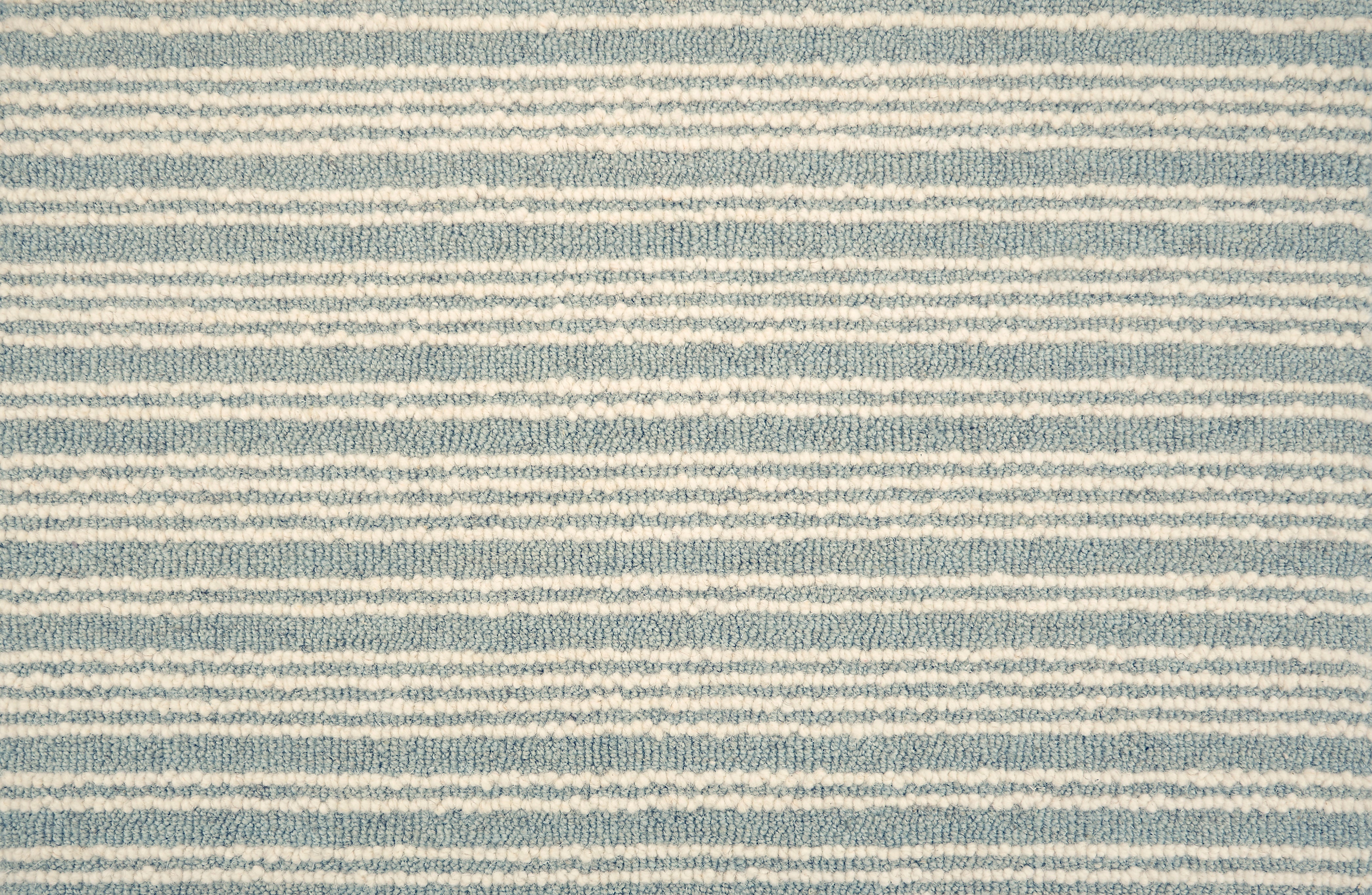 Broadloom carpet with raised cream stripes on light blue. 