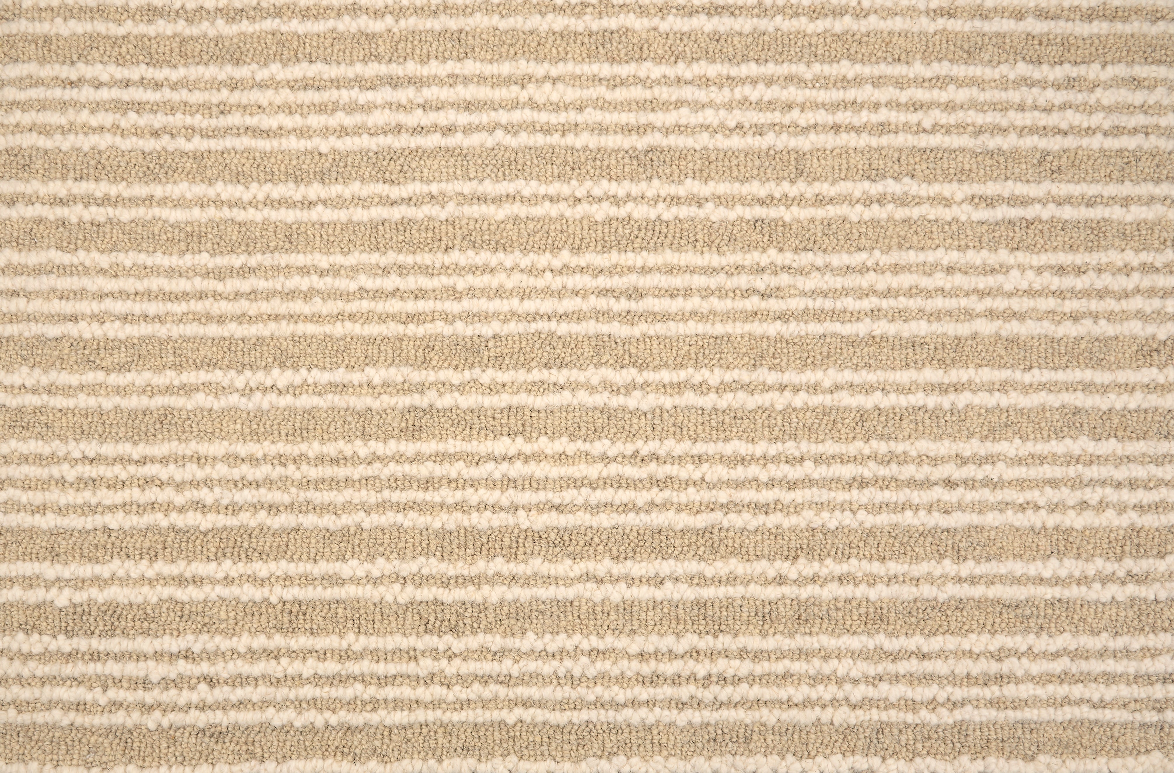 Broadloom carpet with raised cream stripes on tan. 