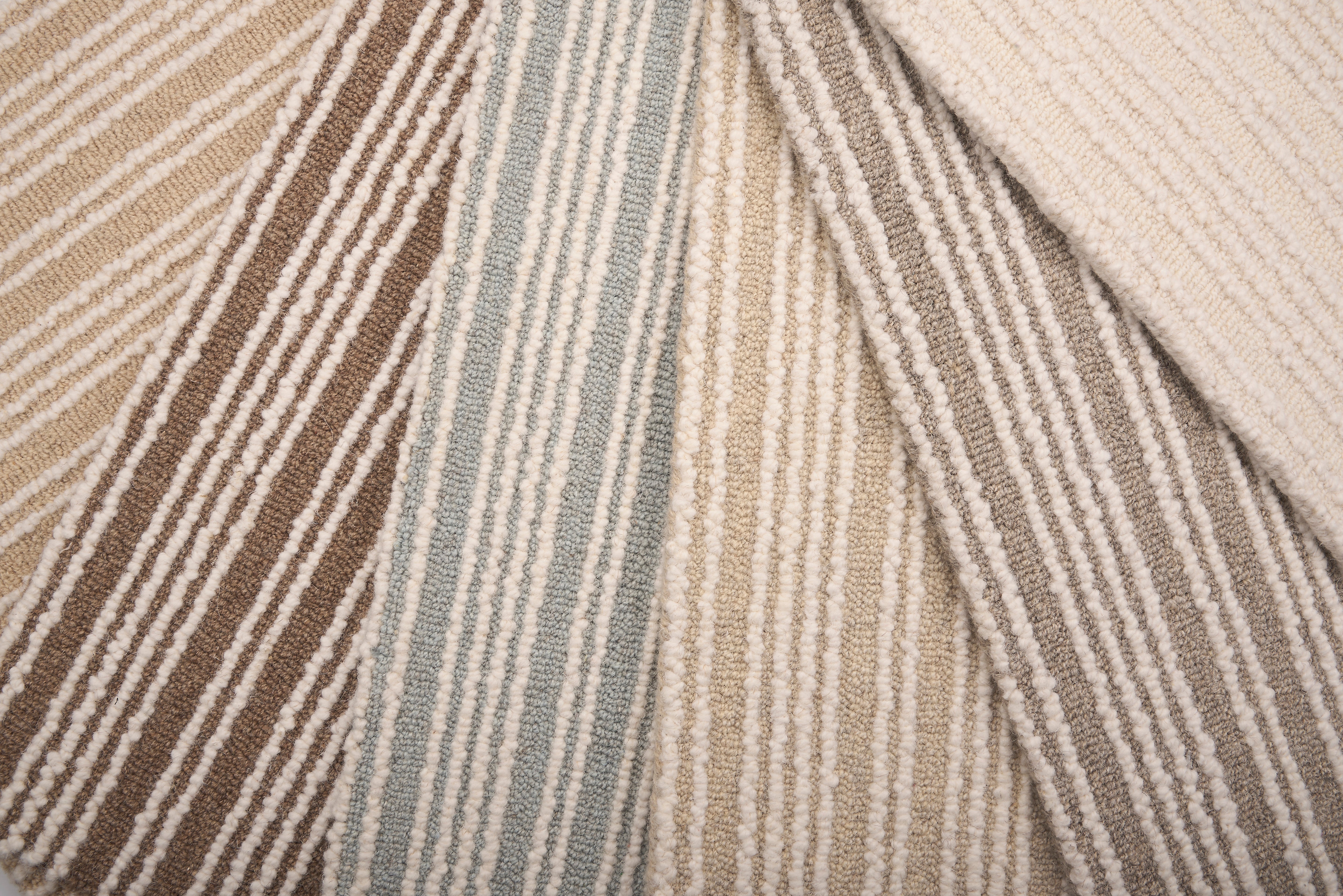 An array of striped broadloom carpets in neutral colors 