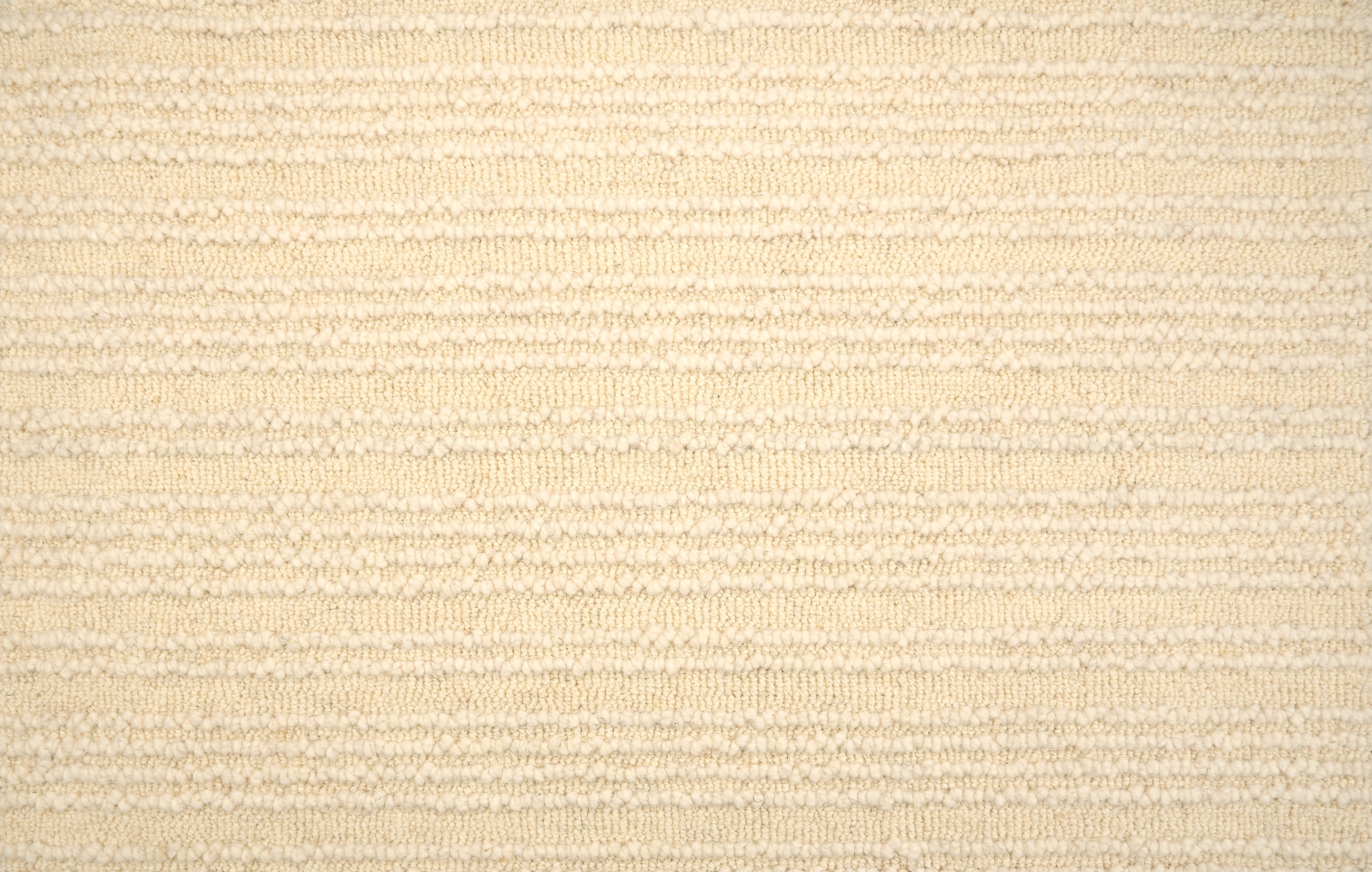 Broadloom carpet with raised cream stripes on cream.