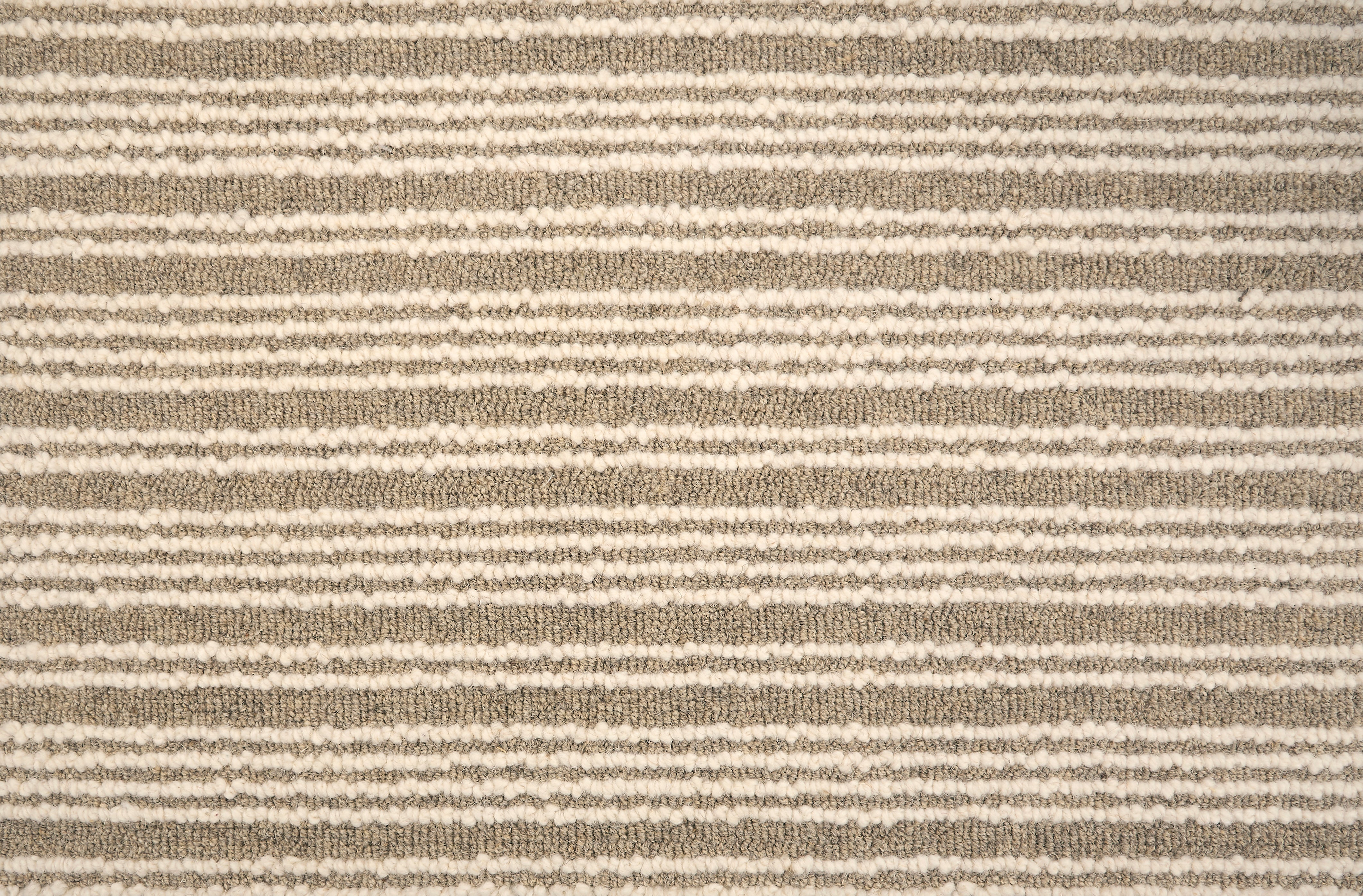 Broadloom carpet with raised cream stripes on taupe. 