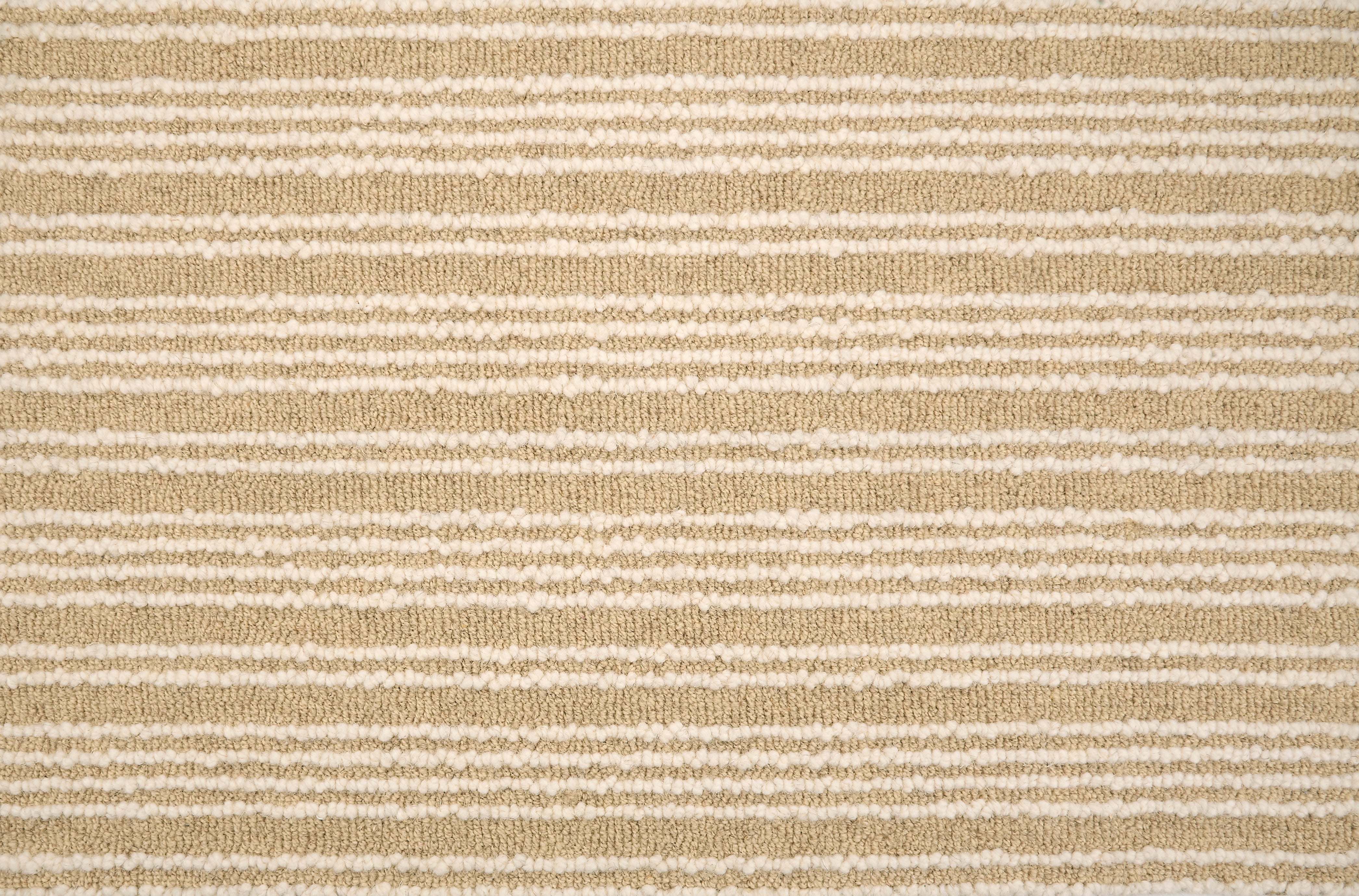 Broadloom carpet with raised cream stripes on tan.