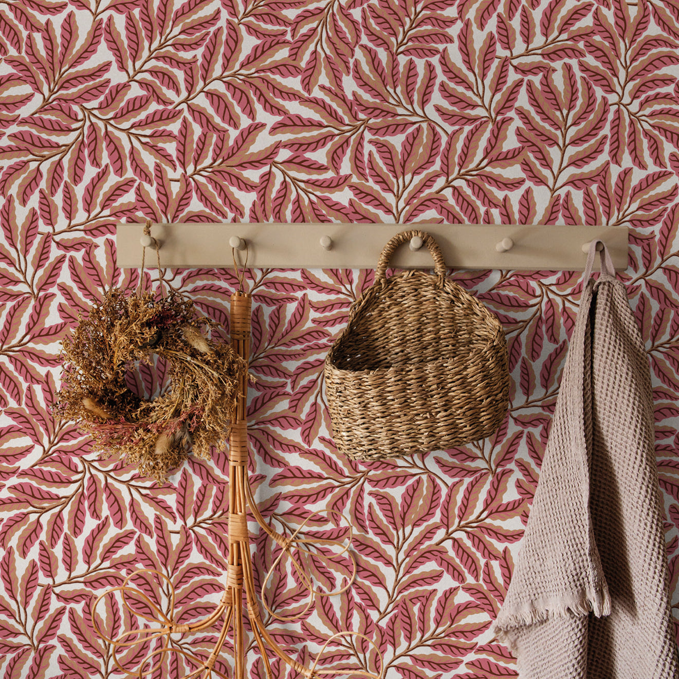 Wall with pink leaf-patterned wallpaper featuring a wooden hook with decorative items.