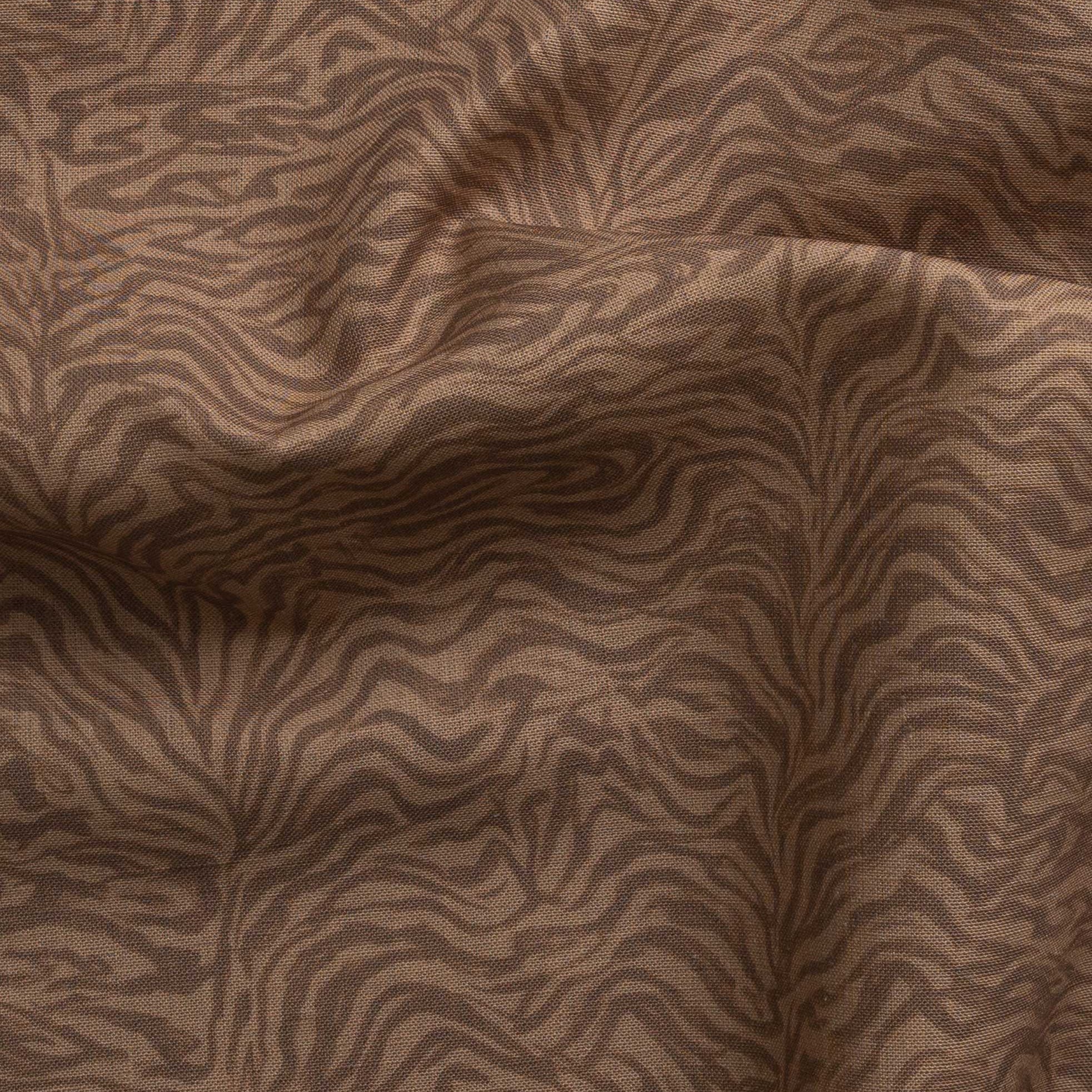 Detail of gently draped printed fabric with watercolor swirling stripe pattern in tonal warm terracotta brown.