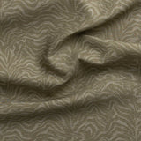 Detail of gently draped printed fabric with watercolor swirling stripe pattern in tonal muted sage green.