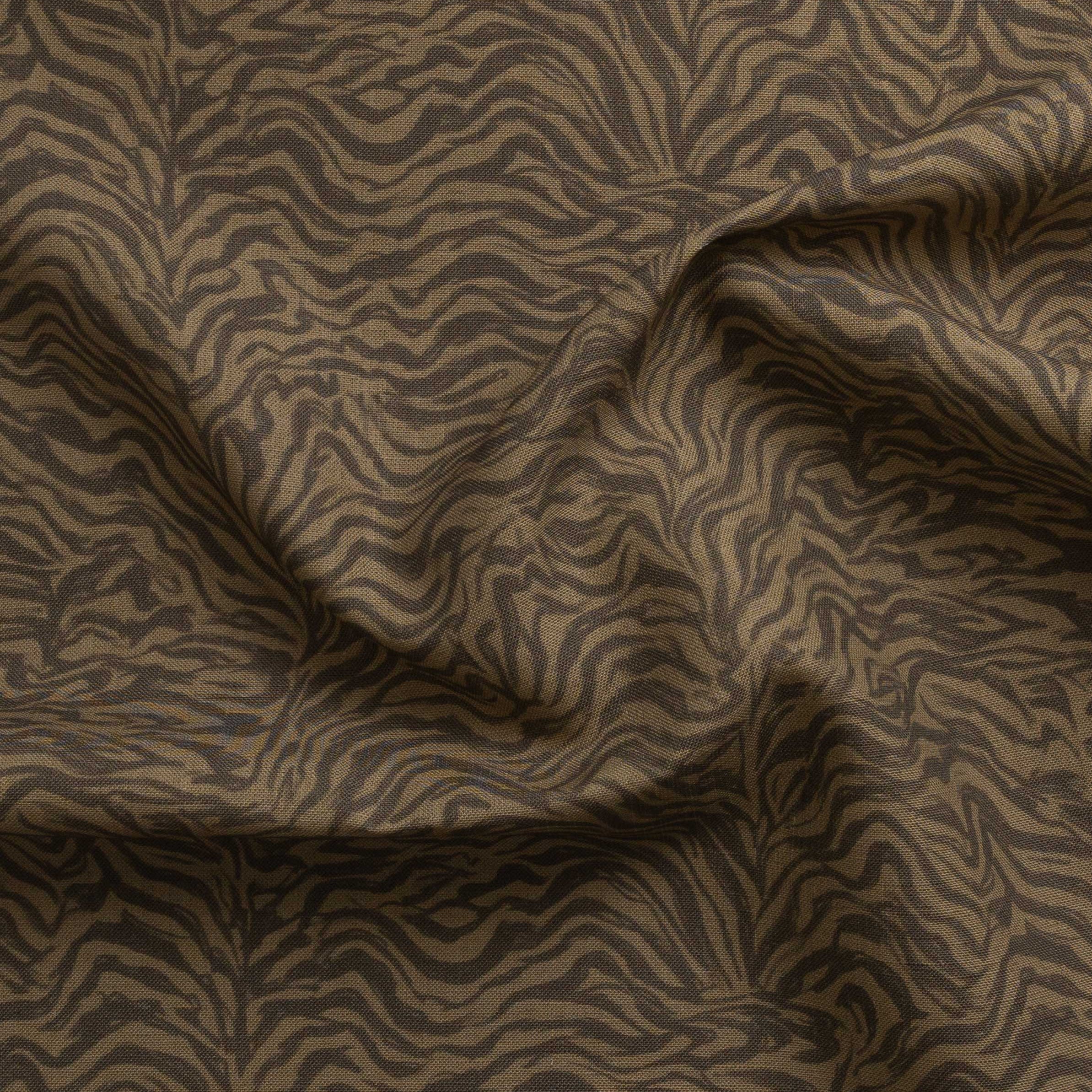 Detail of gently draped printed fabric with watercolor swirling stripe pattern in tonal brown.