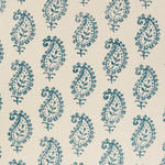 Detail of fabric in a repeating paisley print in navy on a cream field.