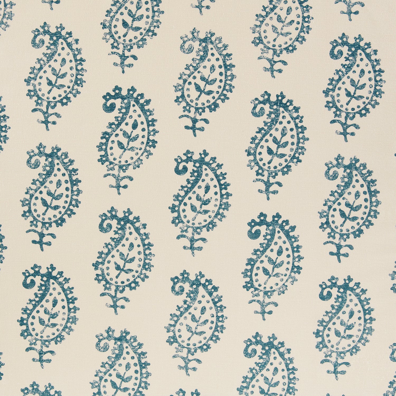 Detail of fabric in a repeating paisley print in navy on a cream field.