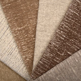 Array of textured carpet samples in neutral colors. 