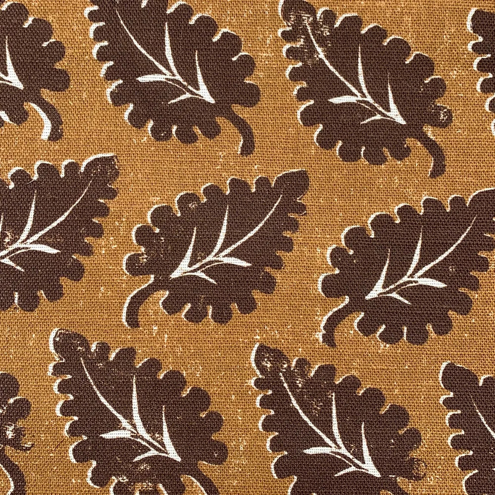 Pattern of brown leaves on a tan background