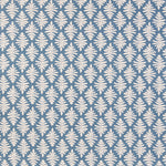 Detail of fabric in a repeating fern leaf print in white on a blue field.