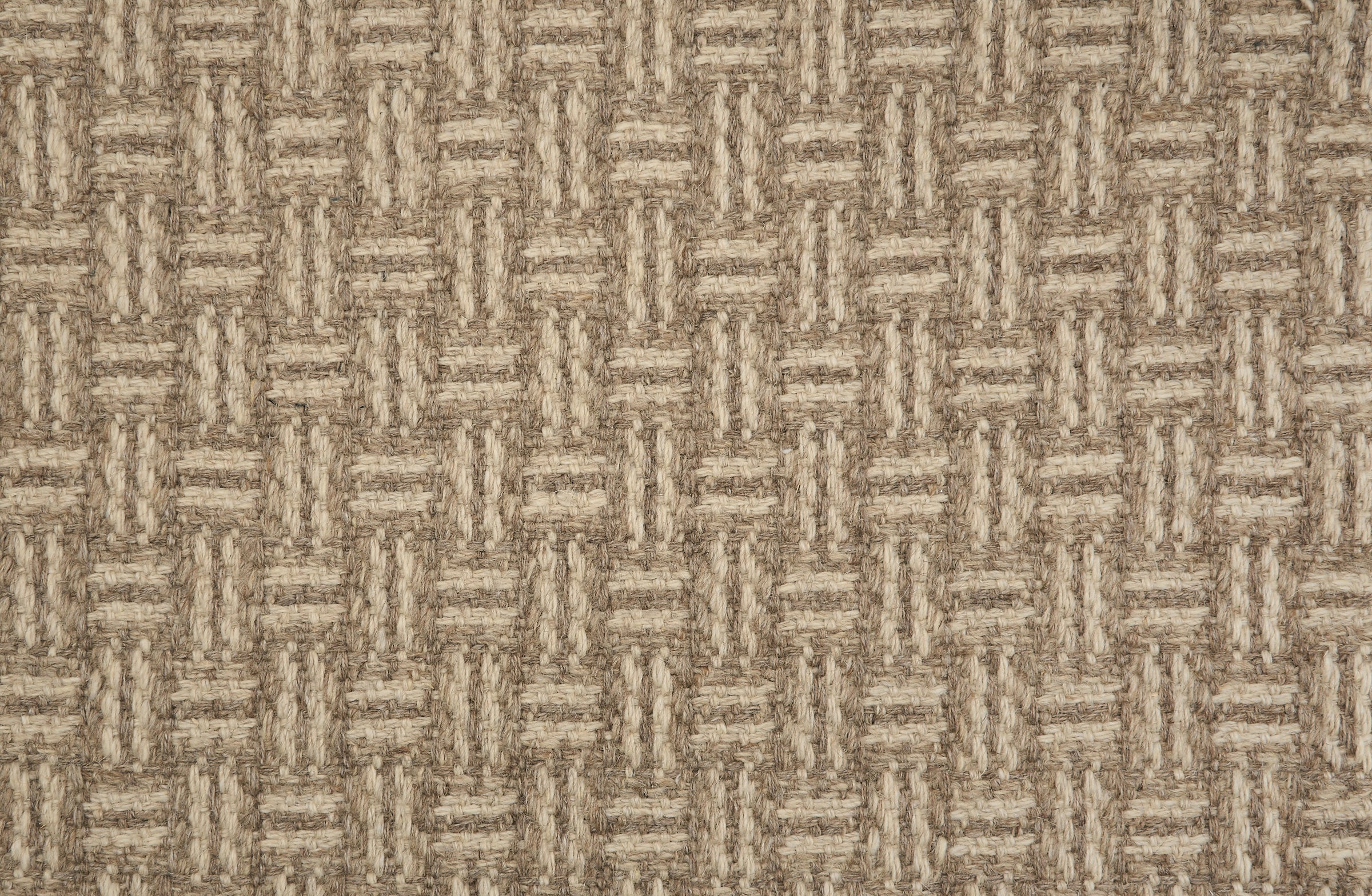 Broadloom carpet with a geometric herringbone design in brown and taupe. 