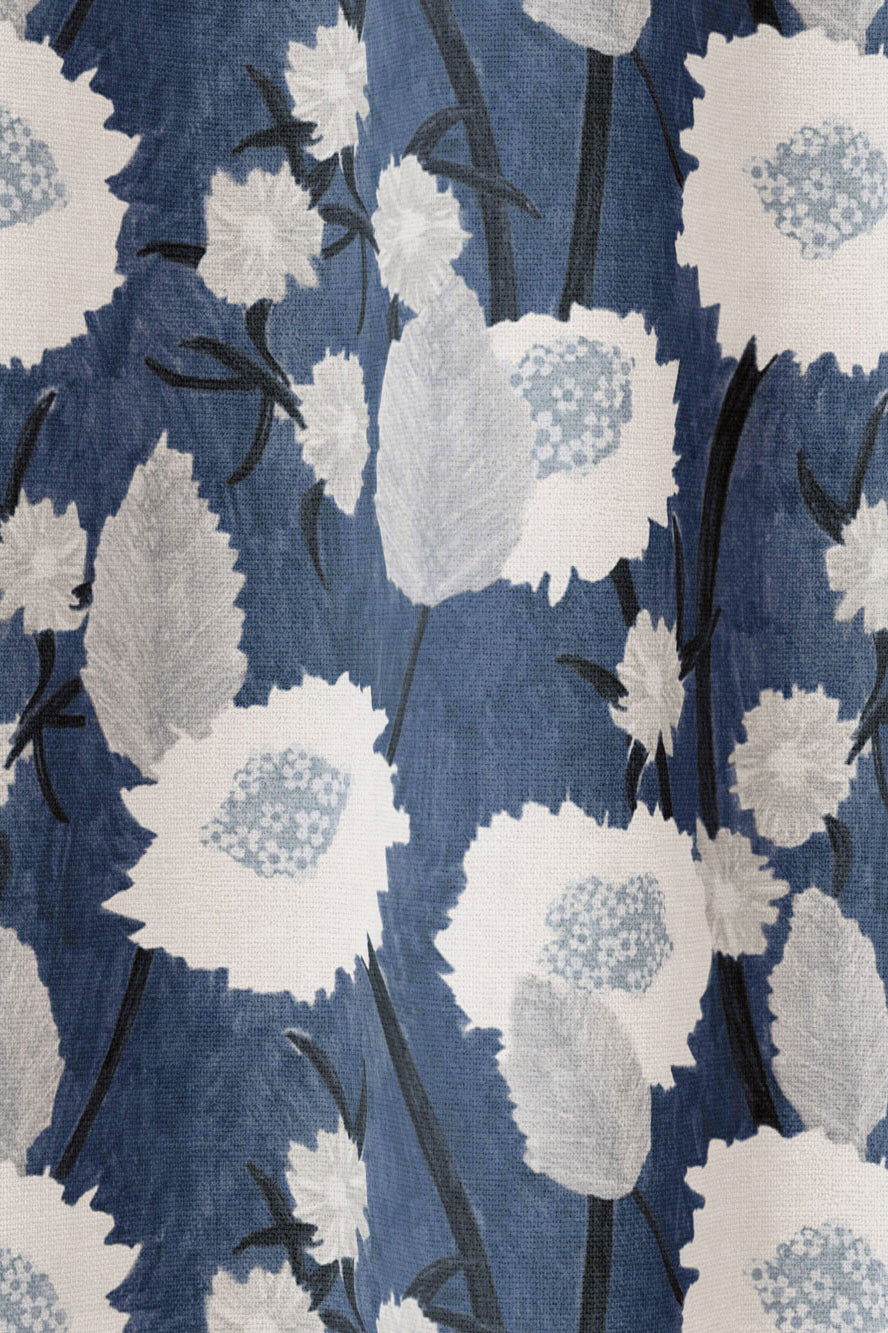 Draped fabric in a playful floral print in shades of white and gray on a navy field.