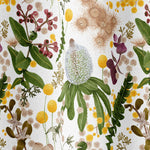 Draped fabric in a large-scale botanical print in shades of pink, yellow and green on a cream field.