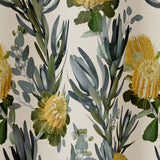 Draped fabric in a photorealistic floral print in shades of yellow, white and green on a cream field.