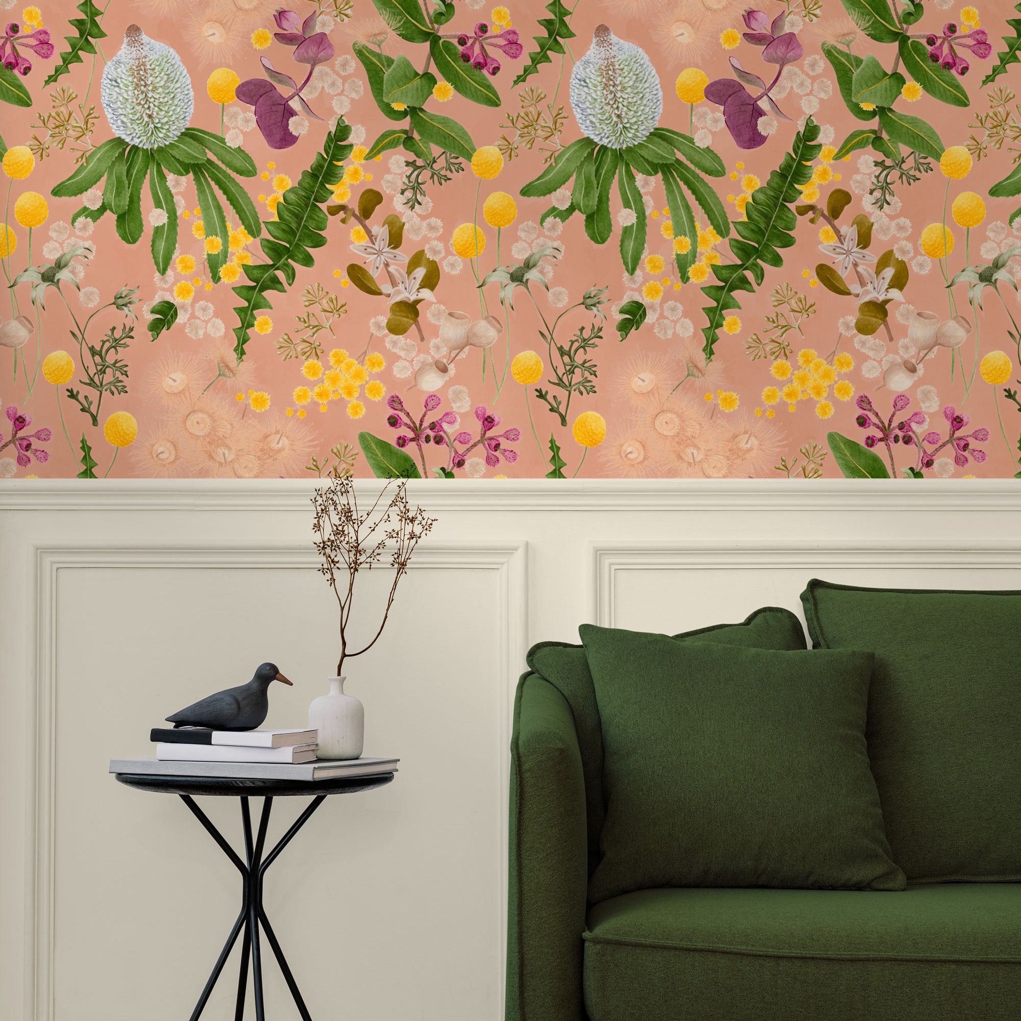 A maximalist living room with a wall papered in a large-scale botanical print in pink, yellow, green and coral.