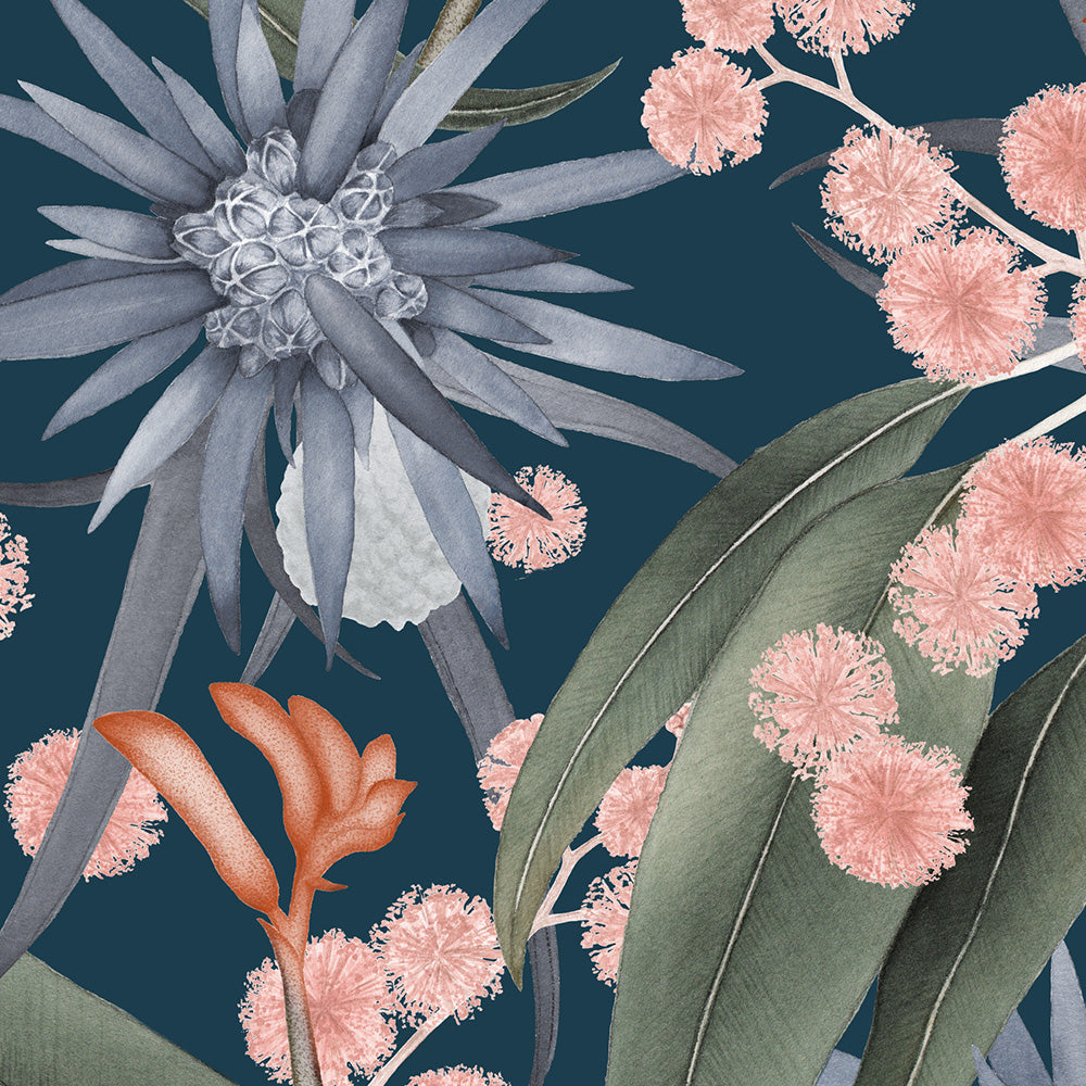 Detail of wallpaper in a large-scale botanical print in shades of blue, green and pink on a navy field.