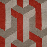 Close-up of a geometric patterned rug with red and gray colors.