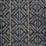 Handwoven rug detail in a diamond design in navy blue and black
