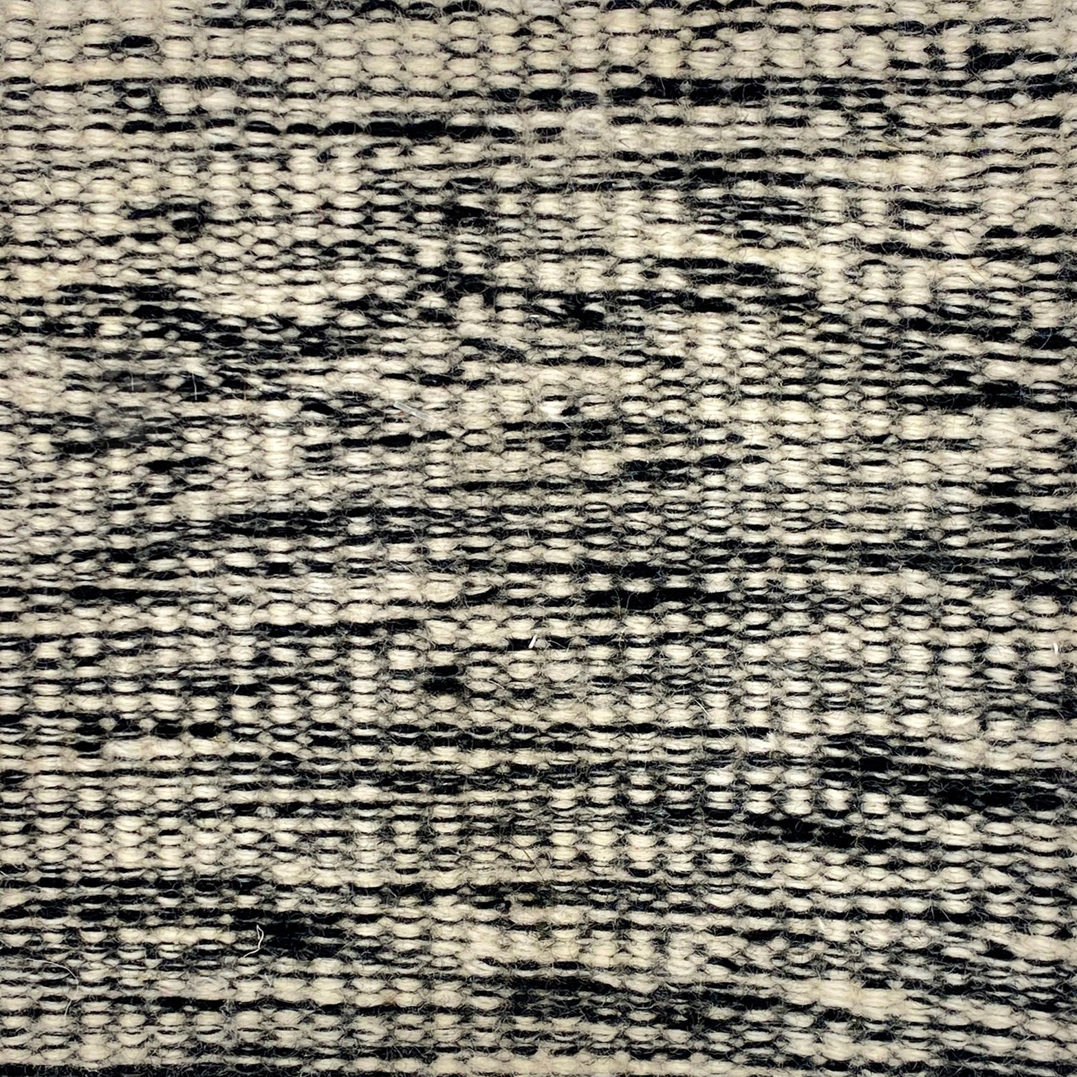 Textured black and white patterned carpet swatch