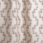 Draped fabric with stripe pattern of stylized dark wine purple leaves on a beige background