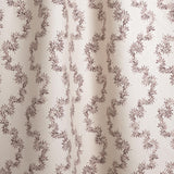 Draped fabric with stripe pattern of stylized dark wine purple leaves on a beige background
