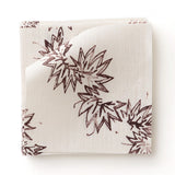 Fabric swatch with stripe pattern of stylized dark wine purple leaves on a beige background