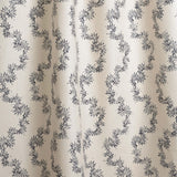 Draped fabric with stripe pattern of stylized dark blue leaves on a beige background
