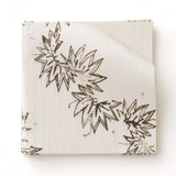 Fabric swatch with stripe pattern of stylized dark brown leaves on a beige background