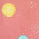 Detail of a wallpaper in a paint splatter print in metallic multicolor pastels on a light pink field.
