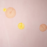 Detail of a wallpaper in a paint splatter print in metallic multicolor pastels on a coral field.