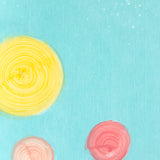 Detail of a wallpaper in a paint splatter print in metallic multicolor pastels on a turquoise field.