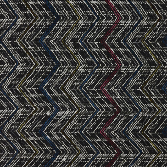 Broadloom carpet in a graphic herringbone stripe in white with primary color accents on a black field. 