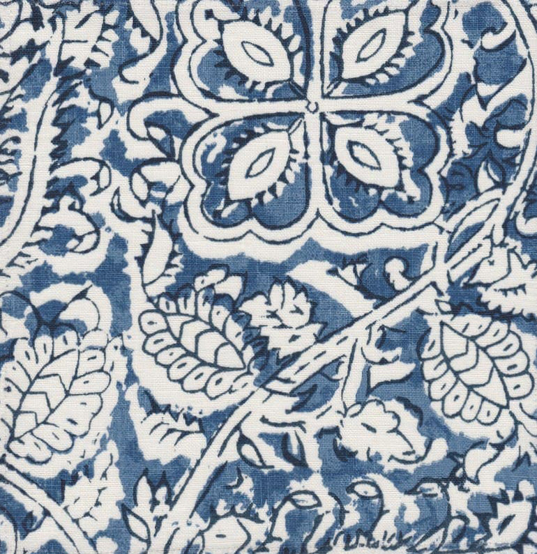 Detail of fabric in a painterly floral paisley in shades of blue and navy on a white field.
