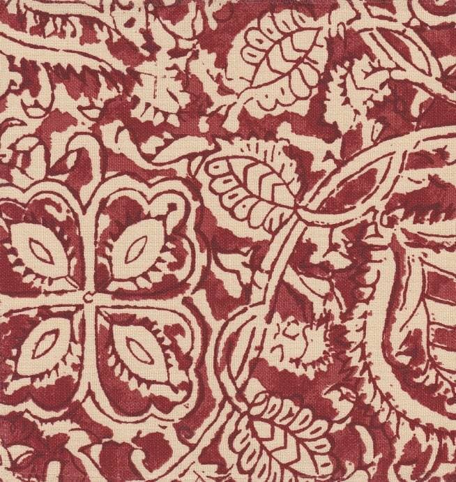 Detail of fabric in a painterly floral paisley in shades of red on a tan field.