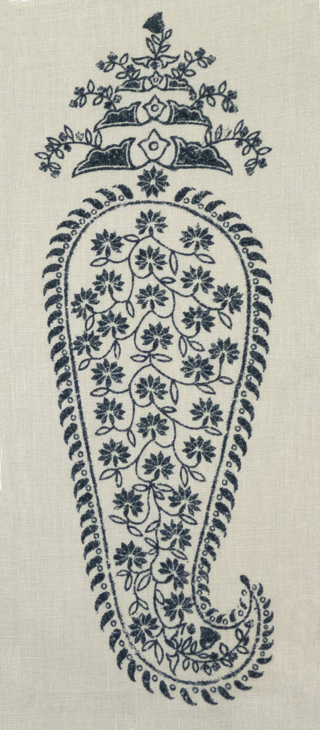 Detail of fabric in an intricate paisley print in indigo on a cream field.