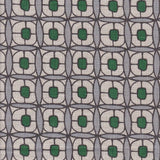 Detail of fabric in a geometric lattice print in green, blue-gray and brown.