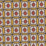 Detail of fabric in a geometric lattice print in red, yellow and brown.