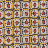 Detail of fabric in a geometric lattice print in red, yellow and brown.
