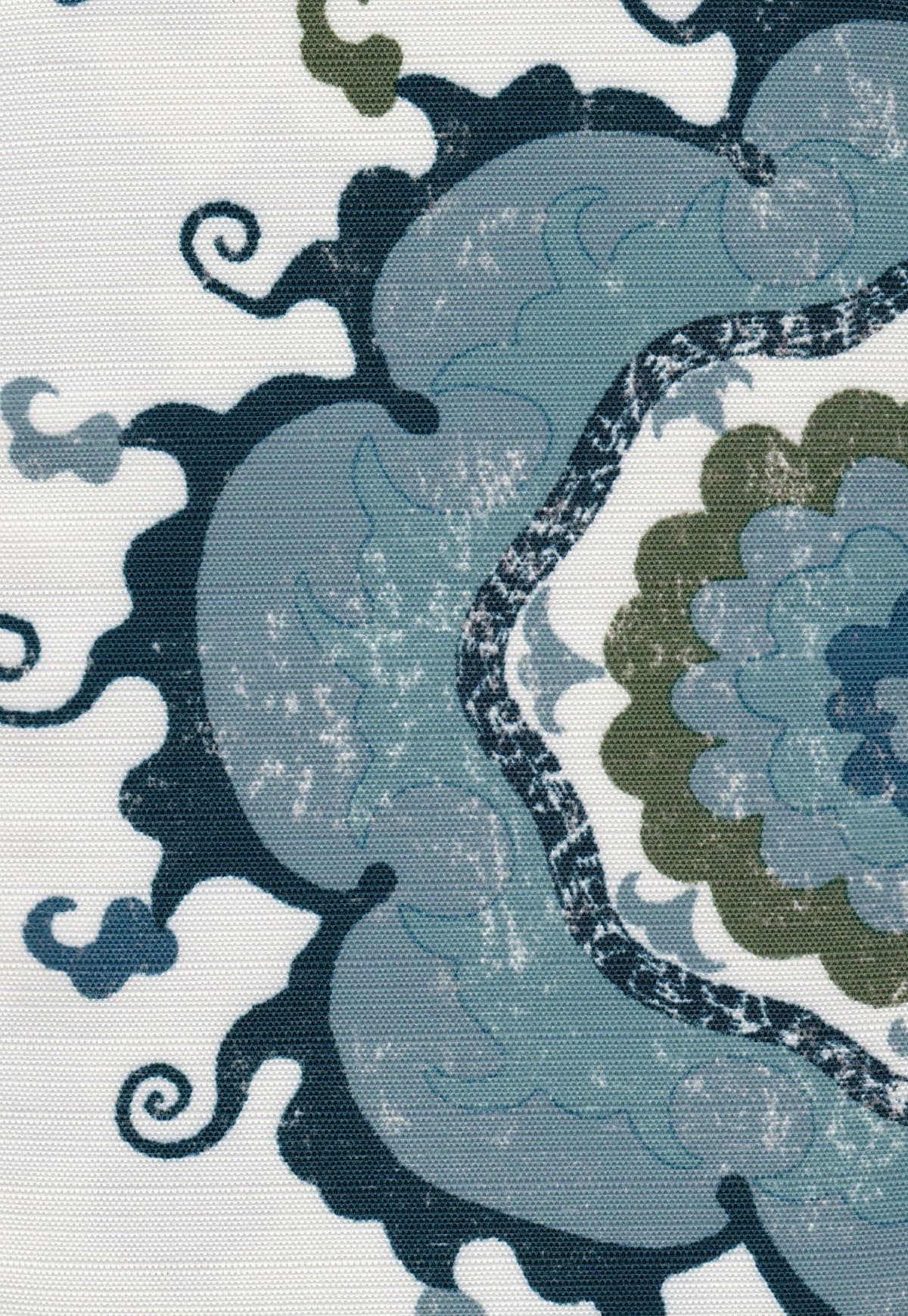 Detail of fabric in a floral paisley print in shades of red, orange, yellow and blue on a tan field.