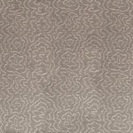 Detail of fabric in a minimalist wood grain print in cream on a gray field.