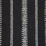 Detail of fabric in an irregular stripe print in white on a black field.