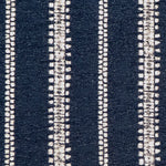 Detail of fabric in an irregular stripe print in white on an indigo field.